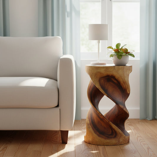 Haussmann Round Double Twist solid wood end table, 14 x 14 x 23 in walnut, styled to the right of a white sofa in a sunlit living room with a lamp and potted plant on top